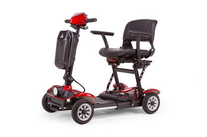 The EW-26 Folding Scooter by E-Wheels is a lightweight red and black mobility scooter with four wheels. It features a padded seat with armrests, tall backrest, handlebars, and a front headlight. Powered by a lithium-ion battery, it's shown in an open position for easy transport.