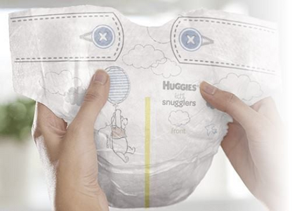 Hands cradle a Huggies Little Snugglers Baby Diaper by McKesson, featuring a playful design with clouds and a bear holding a balloon. This hypoallergenic diaper is ideal for sensitive skin protection, adorned with decorative stitching and blue button illustrations at the top.