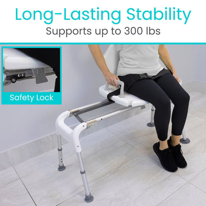 A person sits comfortably on the Vive Health Sliding Shower Chair, a sturdy, adjustable chair with safety locks that supports up to 300 lbs. This white mobility aid features metallic legs and a security strap for lasting stability.