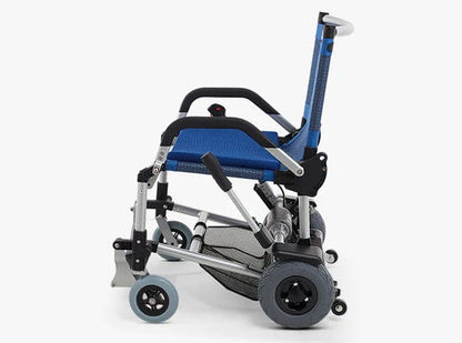 A side view of the ultra-portable, compact foldable wheelchair from Journey Health & Lifestyle showcases a blue fabric seat and backrest. This Zinger Chair with Arm Rests comes equipped with black armrests, a silver frame, and robust gray wheels suitable for multi-surface use, featuring smaller front wheels and larger rear wheels.