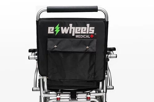 The back view of the EW-M45 Portable Power Wheelchair from E-Wheels showcases a black fabric panel featuring the brand's name and a green lightning bolt symbol. A convenient pocket is neatly sewn onto this panel. The power wheelchair includes a sturdy metal frame and ergonomic black handlebars, making it ideal for travel.