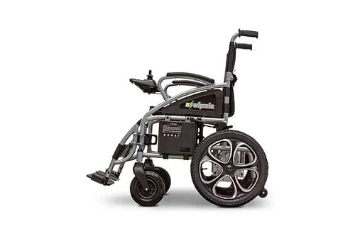 The profile view of the EW-M30 Powered Wheelchair by E-Wheels showcases its silver and black design. It has a compact folding structure, cushioned seat, armrests, sturdy aluminum frame, and large rear wheels for easy maneuverability.