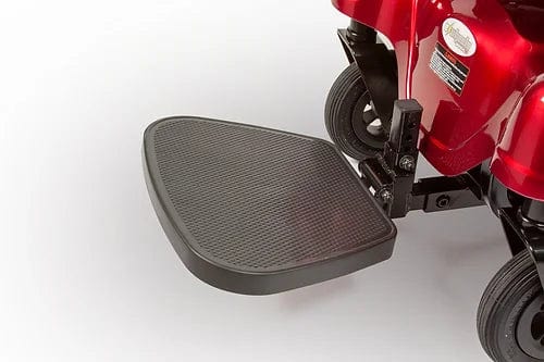 Close-up of a red E-Wheels EW-M31 Compact Power Chair footrest, ideal for both indoor and outdoor use. The black textured footrest is securely attached to the chair's frame and supported by wheels.