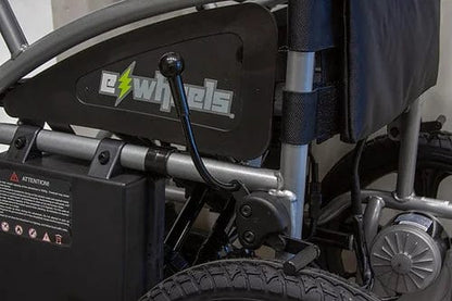 Close-up of an EW-M30 Powered Wheelchair highlighting its side frame with the E-Wheels logo and control lever. This travel-friendly wheelchair features a robust aluminum build with exposed wheels and battery compartment, perfect for mobile adventures.