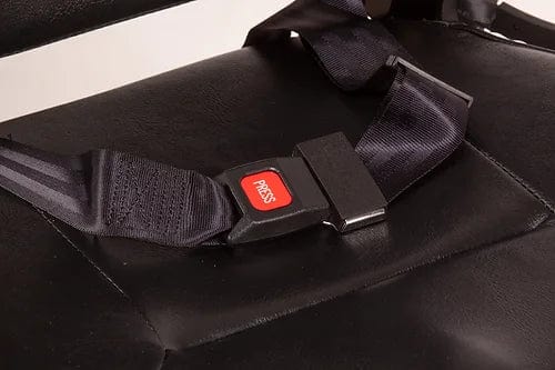 A close-up view of the seatbelt buckle on the EW-M31 Compact Power Chair by E-Wheels showcases its design on a black leather surface, making it perfect for both indoor and outdoor use. The buckle includes a red "Press" button for easy release, with an attached black strap. The slightly textured leather adds a refined touch to your compact power chair experience.