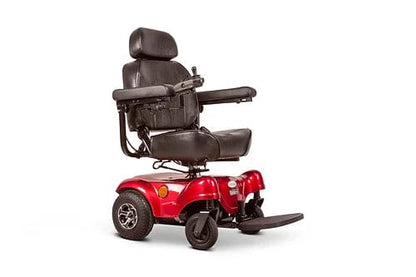 The EW-M31 Compact Power Chair by E-Wheels is a red electric power chair perfect for both indoor and outdoor use. It features a compact design with a black cushioned seat, armrests, a high backrest, and an adjustable headrest. With four wheels for stability and an integrated footplate, this chair is designed for individual transportation.