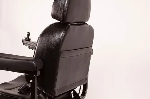 The EW-M31 Compact Power Chair by E-Wheels, shown from a three-quarter rear view against a plain light background, boasts a sleek black leather design with armrests and a high backrest. It features an adjustable headrest for added comfort and is ideal for both indoor and outdoor use, ensuring versatility in any setting.