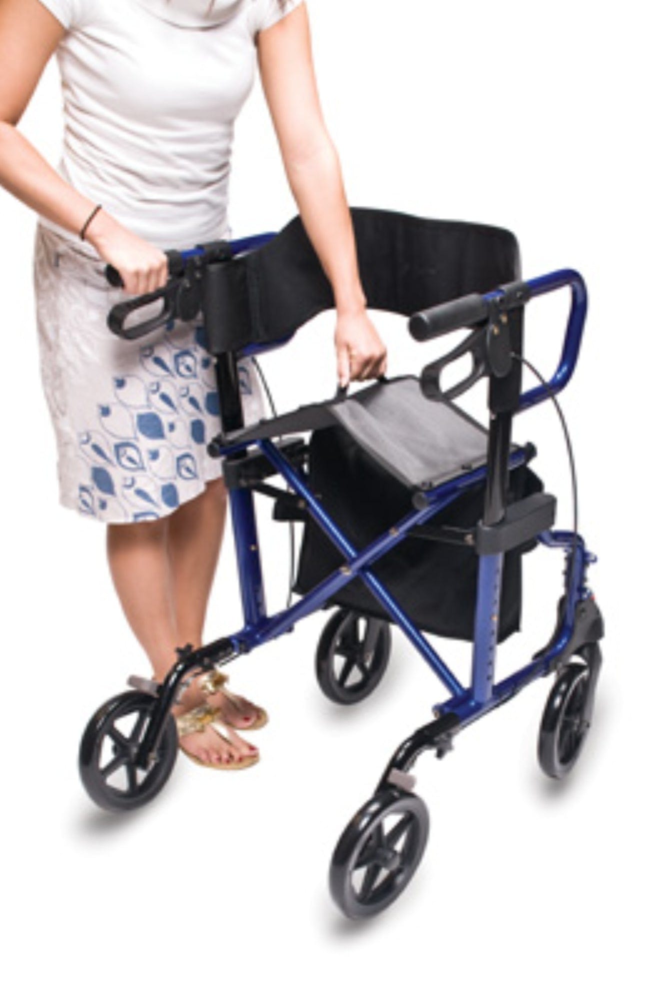 A person in a white top and patterned skirt adjusts the handles of a blue Graham Field HybridLX Rollator Transport Chair, which has a seat, storage pouch, and lightweight four-wheel design ideal for smooth mobility against the stark white background.