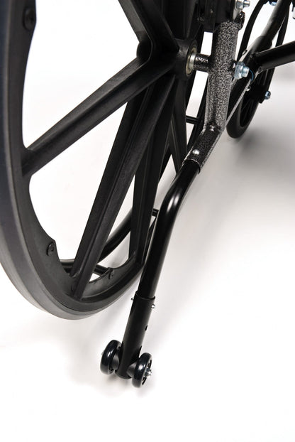 Here's a revised version of the sentence using the given product data:

Close-up view of the rear wheel of the Graham Field Traveler L4 lightweight wheelchair, featuring a quick release axle and anti-tip support. The wheel showcases a robust frame, while the support rod, extending from the main structure, concludes with two small caster wheels against a plain white background.