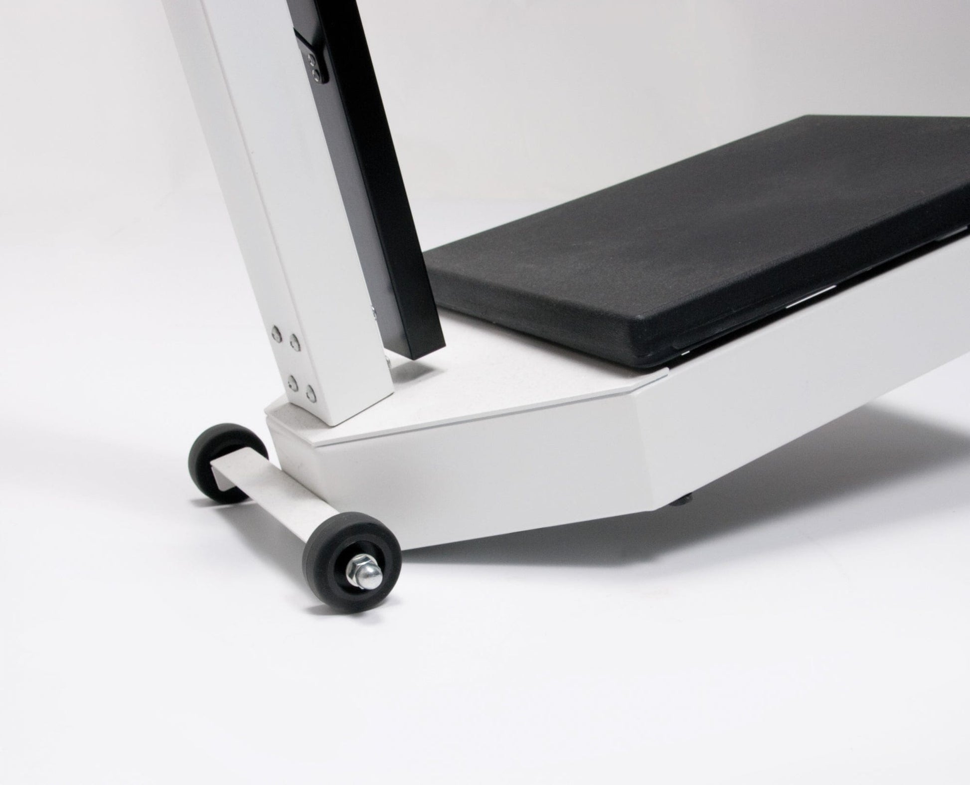 Close-up of the base of the Graham Field Physician Mechanical Beam Scale, showcasing a sturdy black platform and a sleek white frame. Two small wheels suggest portability, while the design supports a significant weight capacity. The plain white background emphasizes this essential dual measurement fitness equipment.