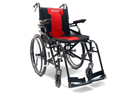 Introducing the So Lite™ C2 Lite Wheelchair by Journey Health & Life Style: a sleek, black manual wheelchair designed for easy portability without compromising on comfort. This compact model comes with a vibrant red cushion and backrest, adjustable footrests and armrests, along with large rear wheels and smaller front wheels for effortless maneuverability.