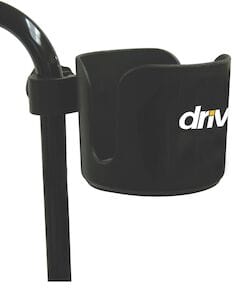 A Universal Cup Holder by Drive Medical is attached to a vertical metal pole, featuring the partially visible text "dri" on its side.