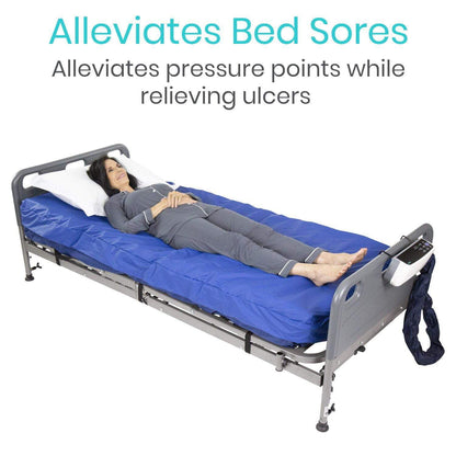 A woman lies comfortably on an 8" Alternating Pressure Mattress by Vive Health, featuring a blue design that expertly prevents bedsores and alleviates pressure points. The text above reads, "Alleviates Bed Sores. Alleviates pressure points while relieving ulcers.