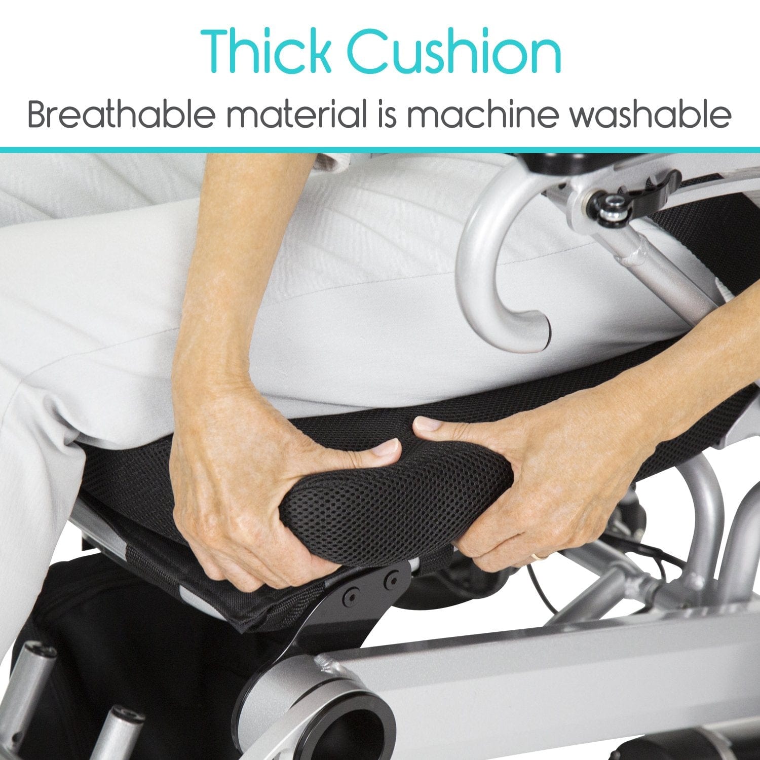 Close-up of an individual adjusting a thick cushion on a Vive Health Power WheelChair. The cushion features breathable, machine washable material. Text above reads: “Thick Cushion” and “Breathable material is machine washable.”