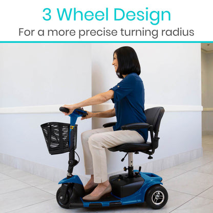 Inside a building, a woman smiles as she sits on the Vive Health 3 Wheel Mobility Scooter. It's blue with variable speeds and features a long-range battery and black front basket. Above her, text reads: "3 Wheel Design For a more precise turning radius.