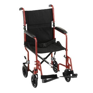 The Nova Medical Transport CH 19 Steel 300LB CAP is a lightweight wheelchair in red and black, equipped with swing-away footrests and four small rear wheels. It includes a safety belt, features a sturdy metal frame, and has black fabric for the seat and backrest. Ideal for easy mobility, it folds effortlessly to compact dimensions.