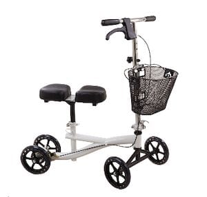 The Compass Health Knee Scooter 8-Hole Stem features a white frame with four wheels, a padded knee rest, and a metal basket on the handlebars. It includes a hand brake for control, making it a reliable mobility aid.