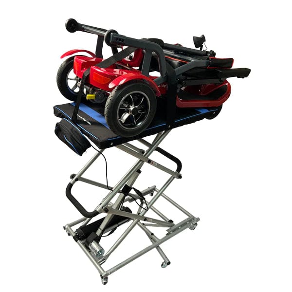 A Journey Health & Life Style So Lite Portable Lift holds a red mobility scooter powered by a lithium-ion battery, folded compactly. Its adjustable scissor design allows for easy height changes, and its locking caster wheels ensure effortless mobility.